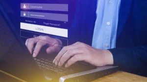 A professional wearing a suit and typing on a laptop with a login screen overlay displaying username and password fields, and options to log in or register.