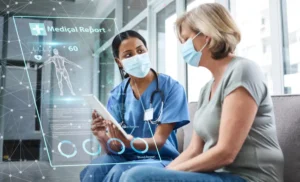 A healthcare professional in a blue scrub and mask discusses a digital medical report with an older female patient, who is also wearing a mask, in a modern medical facility.