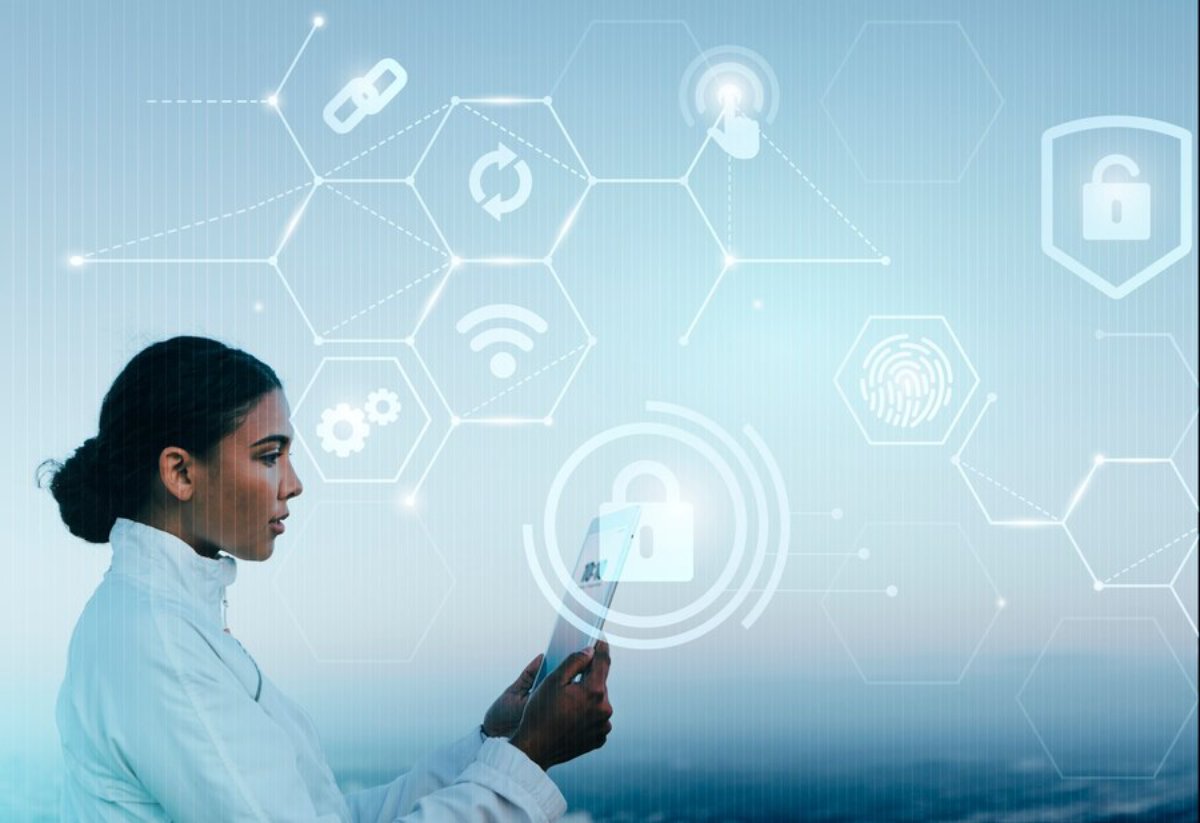 Woman using a tablet with digital icons for security and technology concepts overlaying a blue background.