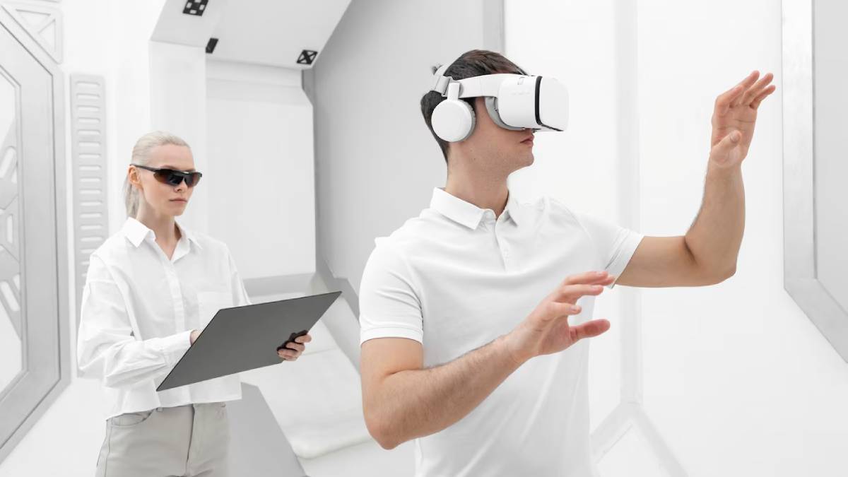 A man wearing a VR headset gestures enthusiastically while a woman in a white shirt takes notes on a clipboard in a modern environment.