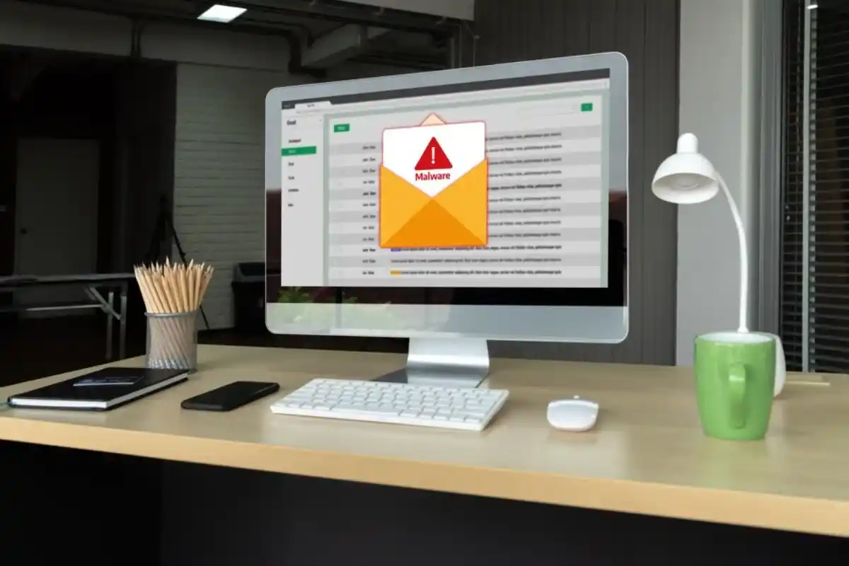 Desktop computer displaying malware alert