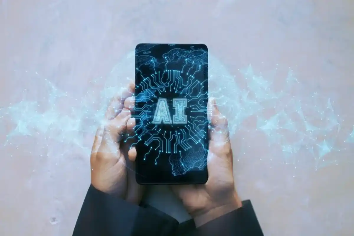 A person holding a smartphone displaying a glowing AI and circuit design, with digital network connections emanating from the device.